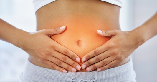 Close-up of a woman's abdomen highlighted, symbolizing pain or discomfort.