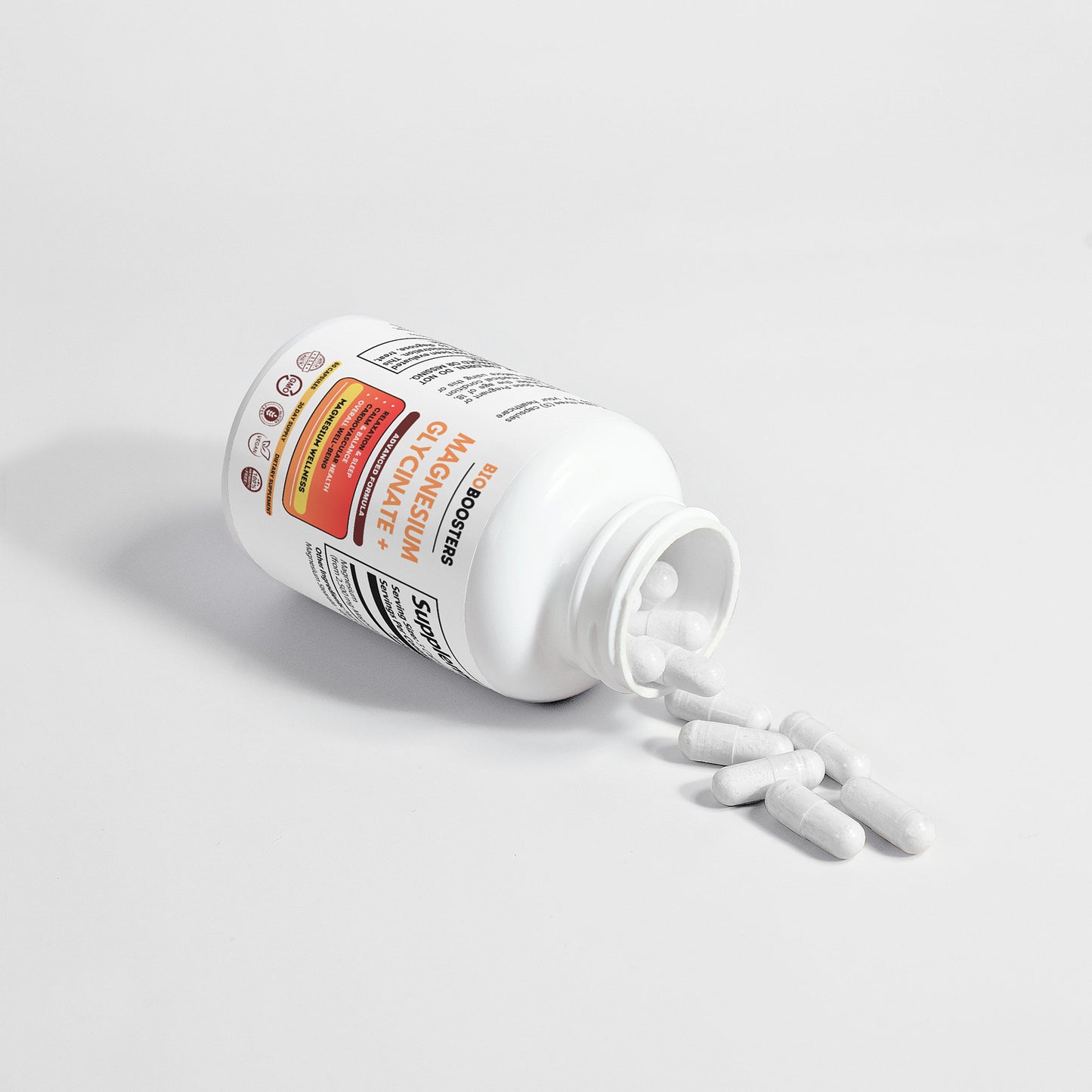 Supplement bottle with white capsules spilling out on a light gray background